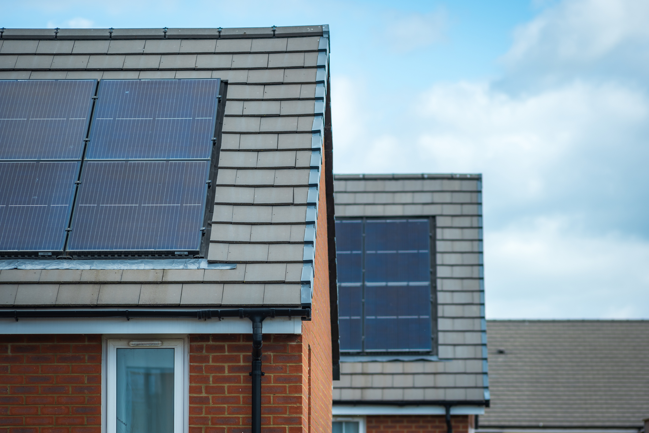 Solar panels mounted on the roof of a modern new-build house in England UK